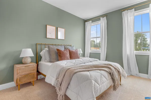 a view of a house with a yard and large trees