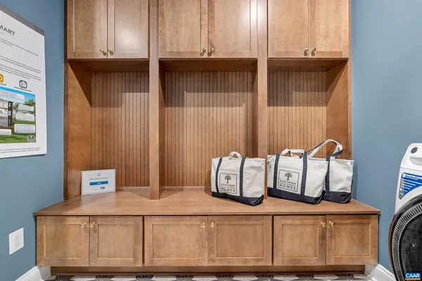 a kitchen with stainless steel appliances granite countertop a refrigerator a oven a sink a dining table and chairs with wooden floor