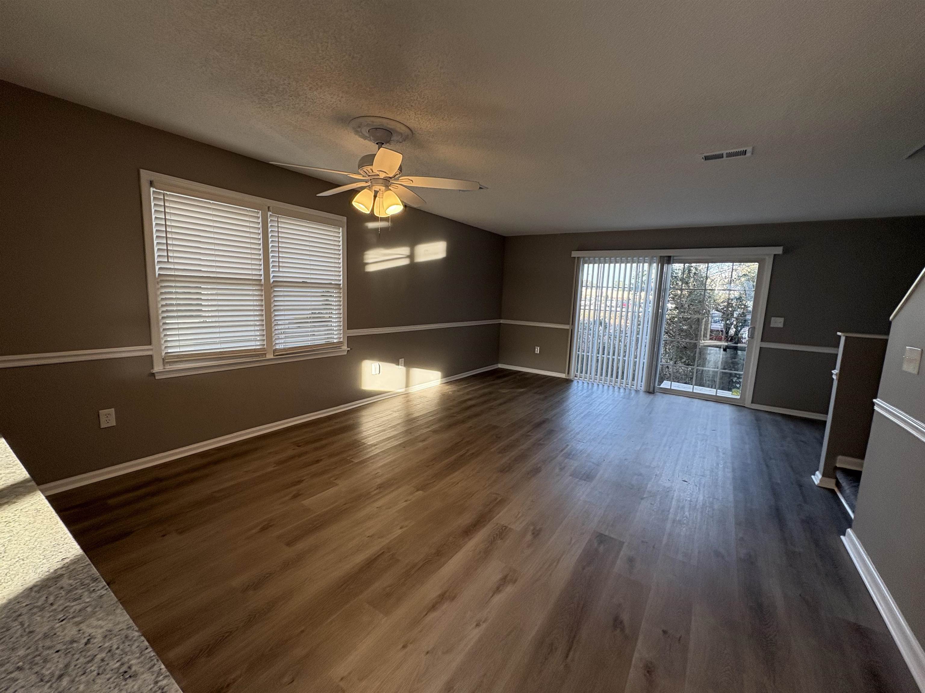 4641 Socastee Boulevard, Unit D1 Myrtle Beach, SC 29588 - Photo 5 of 12 Unfurnished living room featuring a textured ceiling, dark wood finished floors, and ceiling fan