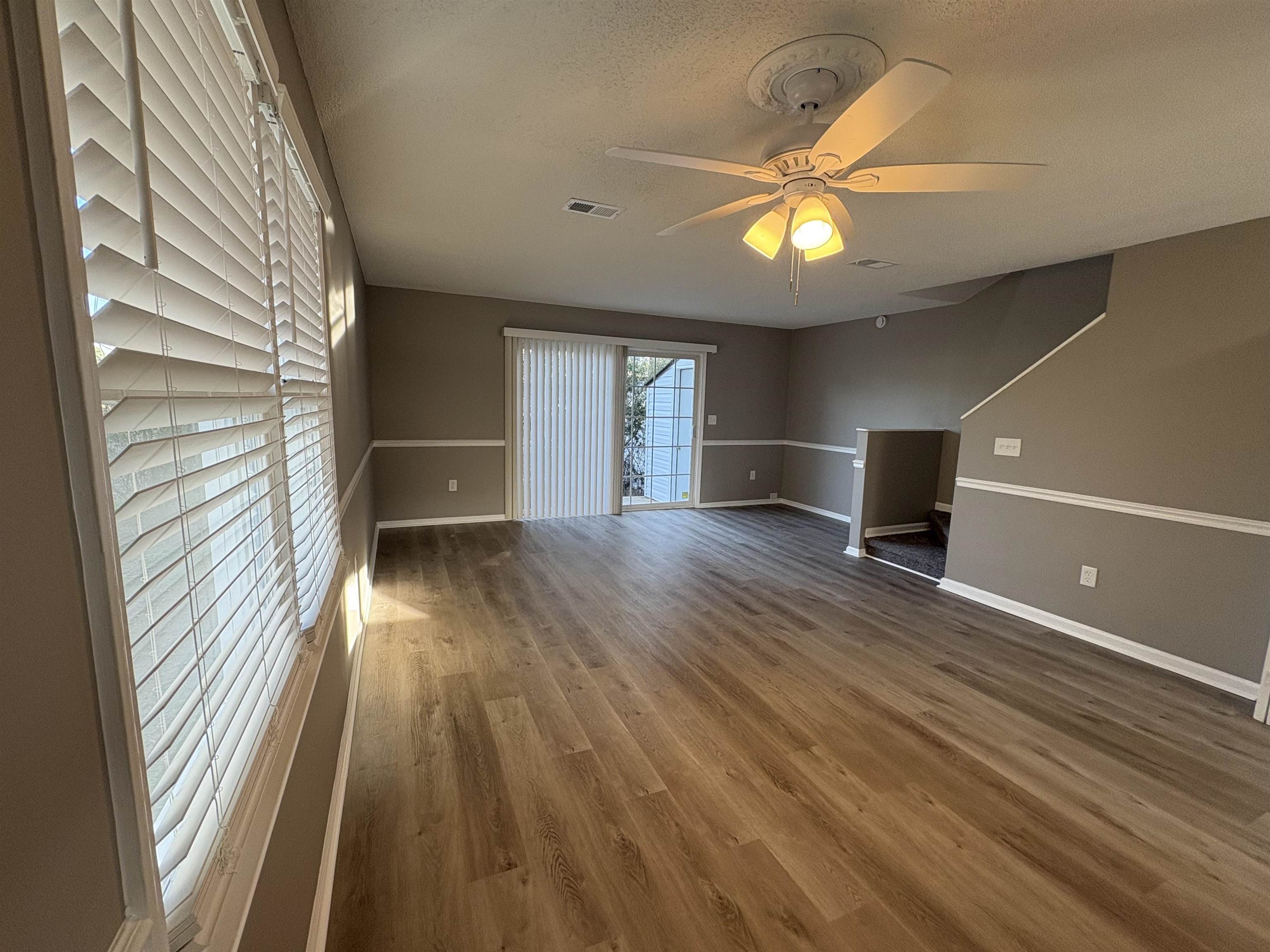 4641 Socastee Boulevard, Unit D1 Myrtle Beach, SC 29588 - Photo 6 of 12 Spare room featuring wood finished floors, a ceiling fan, and a textured ceiling
