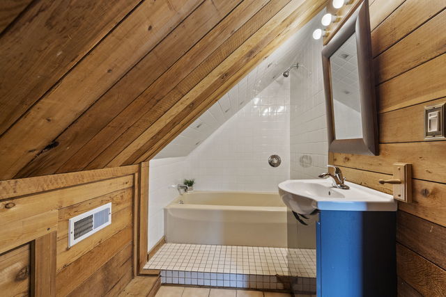 438 South Wright Street Naperville, IL 60540 - Photo 15 of 26 a bathroom with a sink and a bathtub