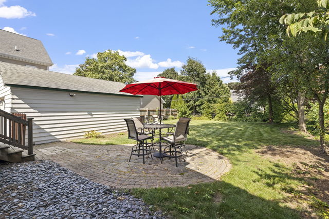 438 South Wright Street Naperville, IL 60540 - Photo 20 of 26 a view of a patio with a table chairs and a yard