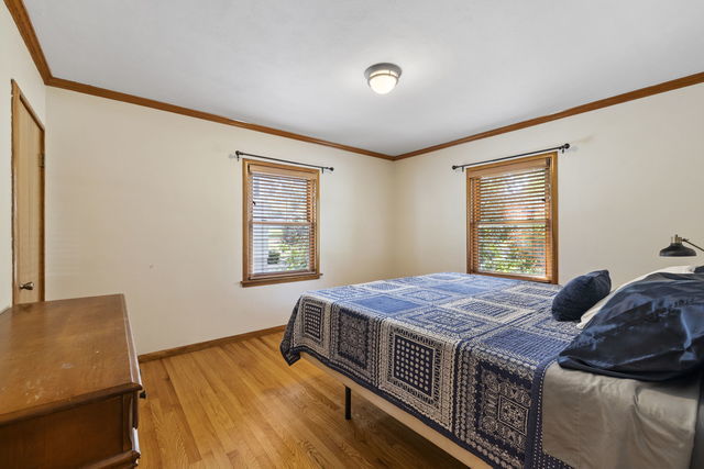 438 South Wright Street Naperville, IL 60540 - Photo 8 of 26 a bed sitting in a bedroom next to a window