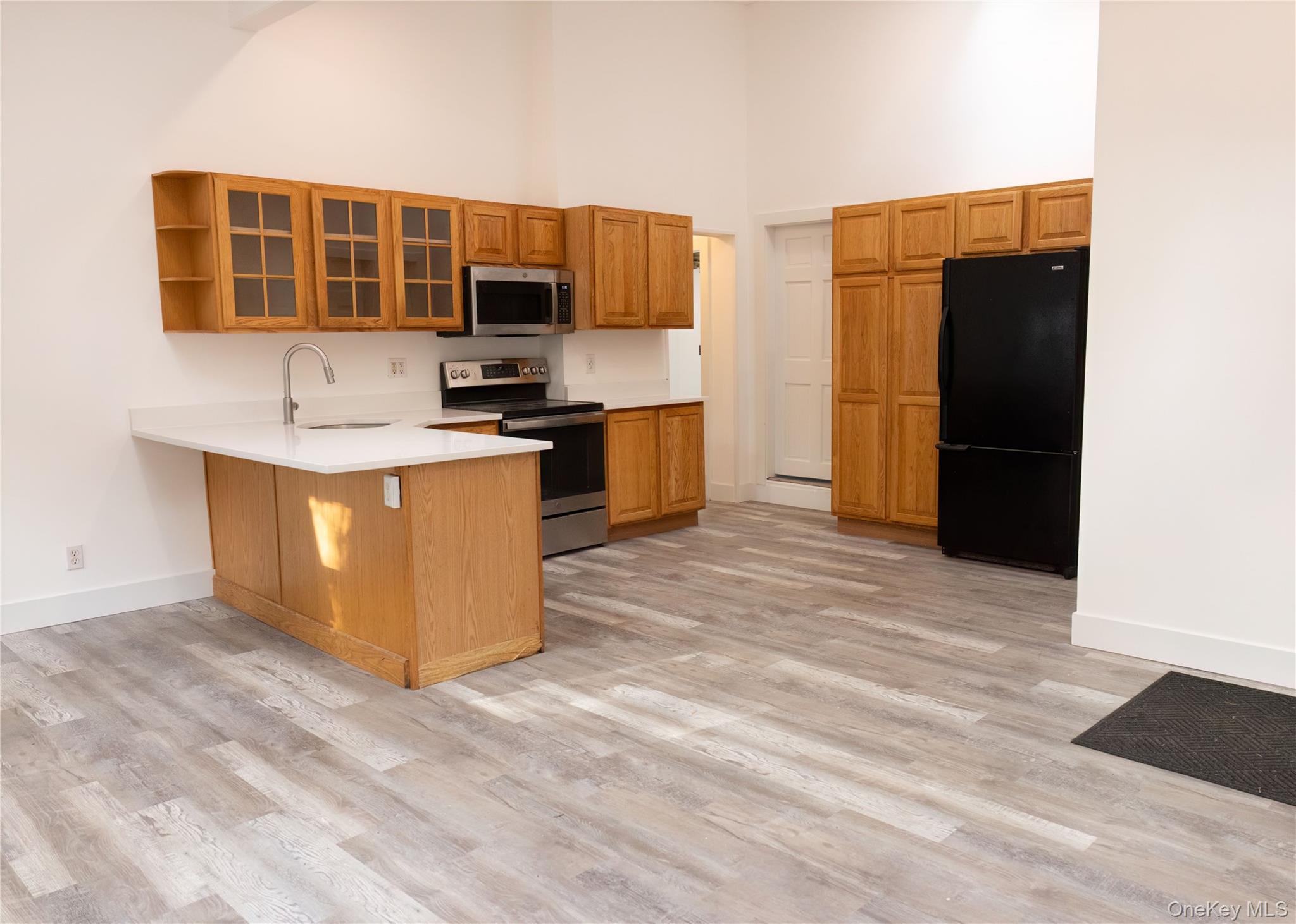 23 Lucille Road Carmel, NY 10512 - Photo 25 of 44 a kitchen with stainless steel appliances kitchen island granite countertop a refrigerator and a stove top oven