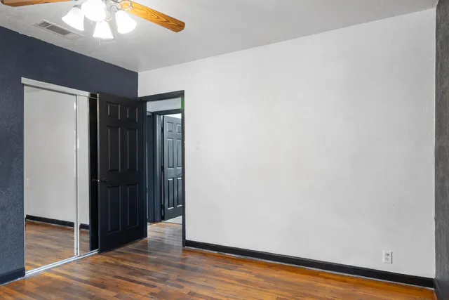a view of hallway with wooden floor