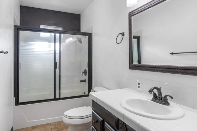 a bathroom with a sink toilet and shower