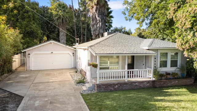 a view of a house with a yard and a garden