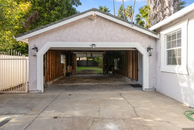 a view of a house with a garage and yard