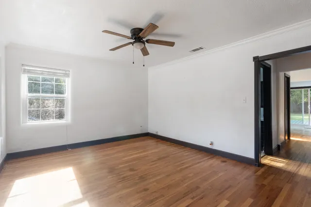 wooden floor in an empty room with a window