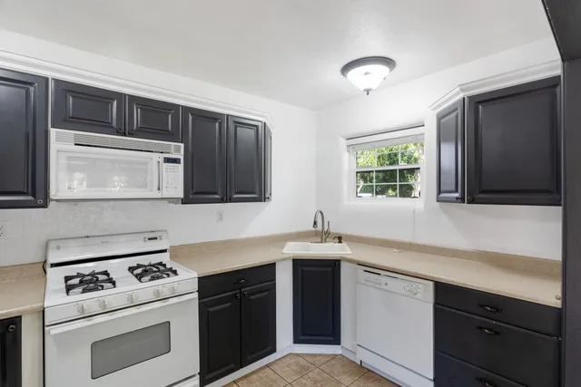 a kitchen with a sink stove and microwave