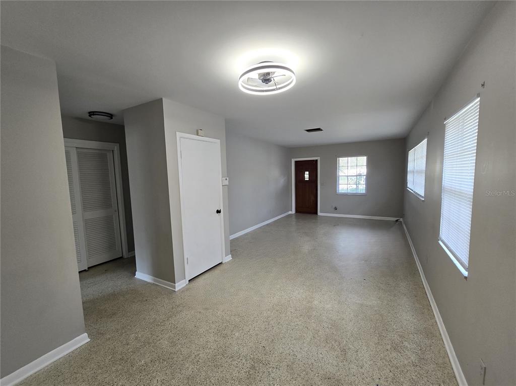 215 Clemons Road Brandon, FL 33510 - Photo 2 of 8 a view of an empty room with window and wooden floor