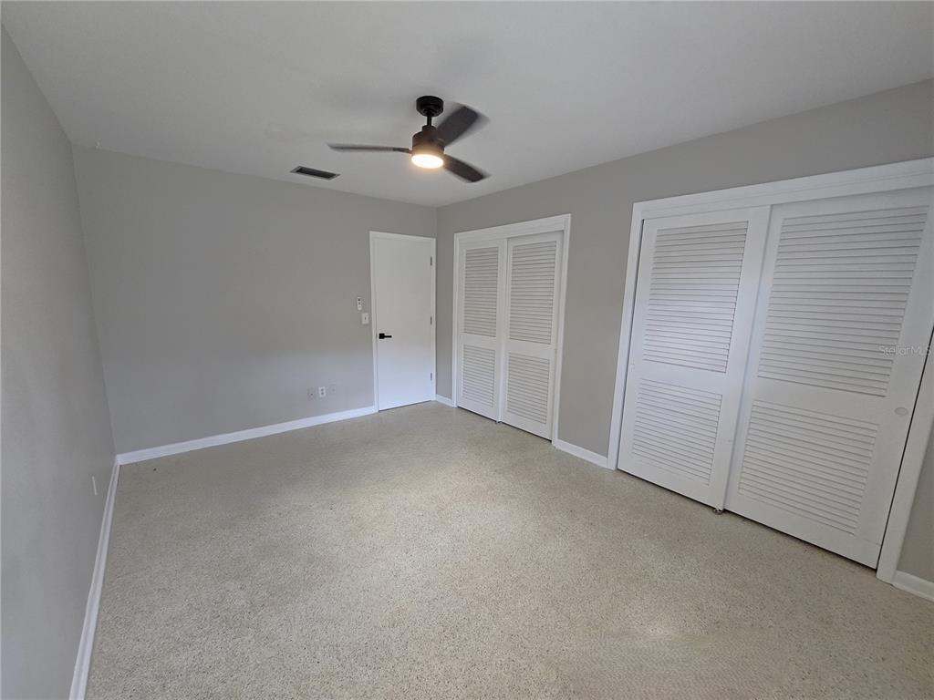 215 Clemons Road Brandon, FL 33510 - Photo 5 of 8 a view of an empty room and chandelier fan