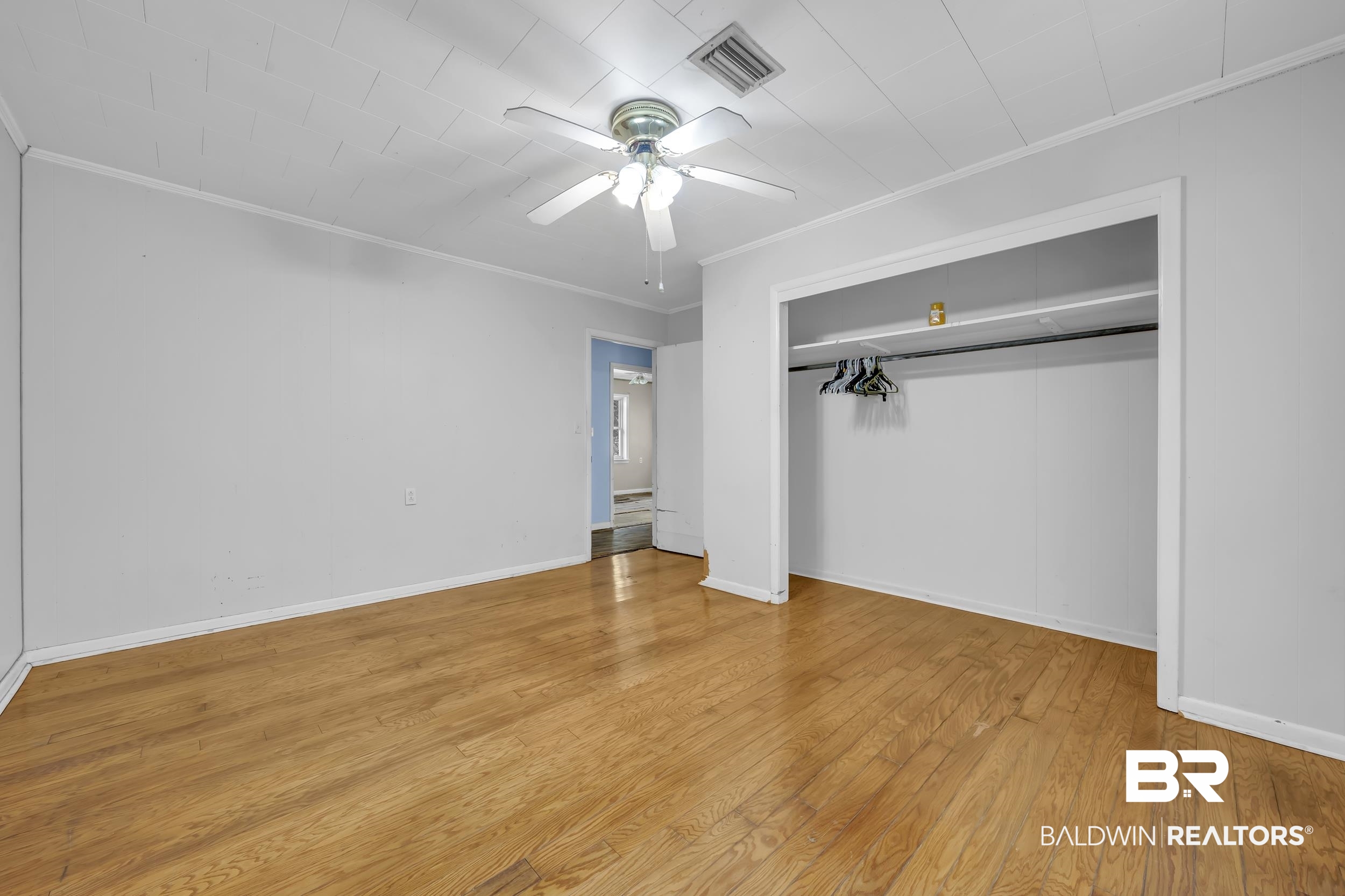 17463 Highway 98 Foley, AL 36535 - Photo 19 of 57 Unfurnished bedroom featuring a closet, ornamental molding, a ceiling fan, and light wood finished floors