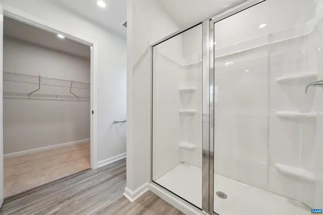 a bathroom with a glass shower door