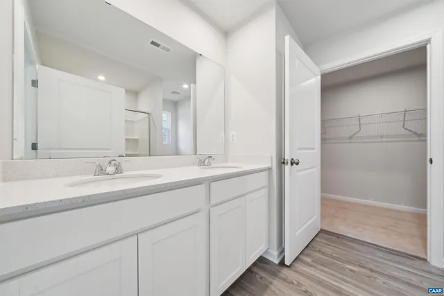 a bathroom with a double vanity sink and mirror