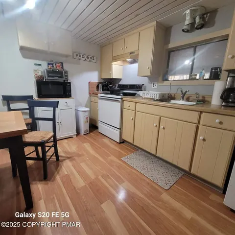 a kitchen with a sink cabinets and stainless steel appliances