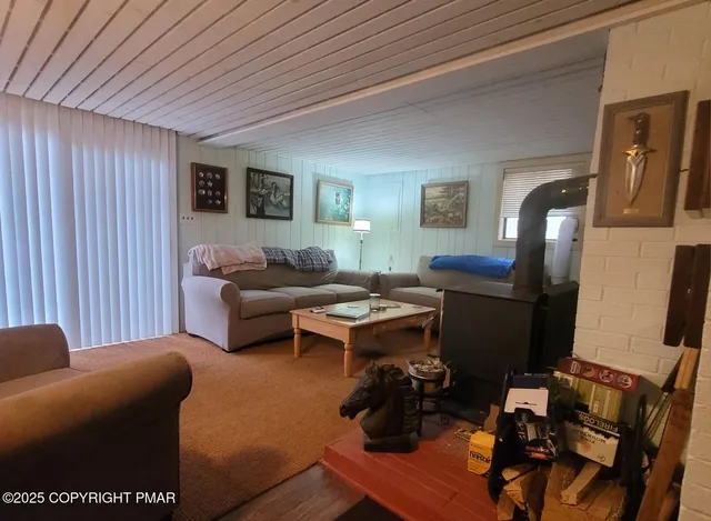 a living room with furniture a flat screen tv and a table