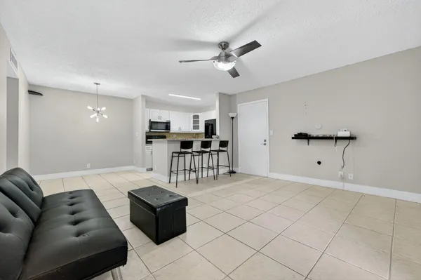 a living room with furniture and kitchen view