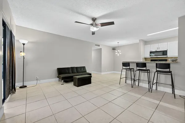 a kitchen with stainless steel appliances kitchen island granite countertop a refrigerator and a stove top oven