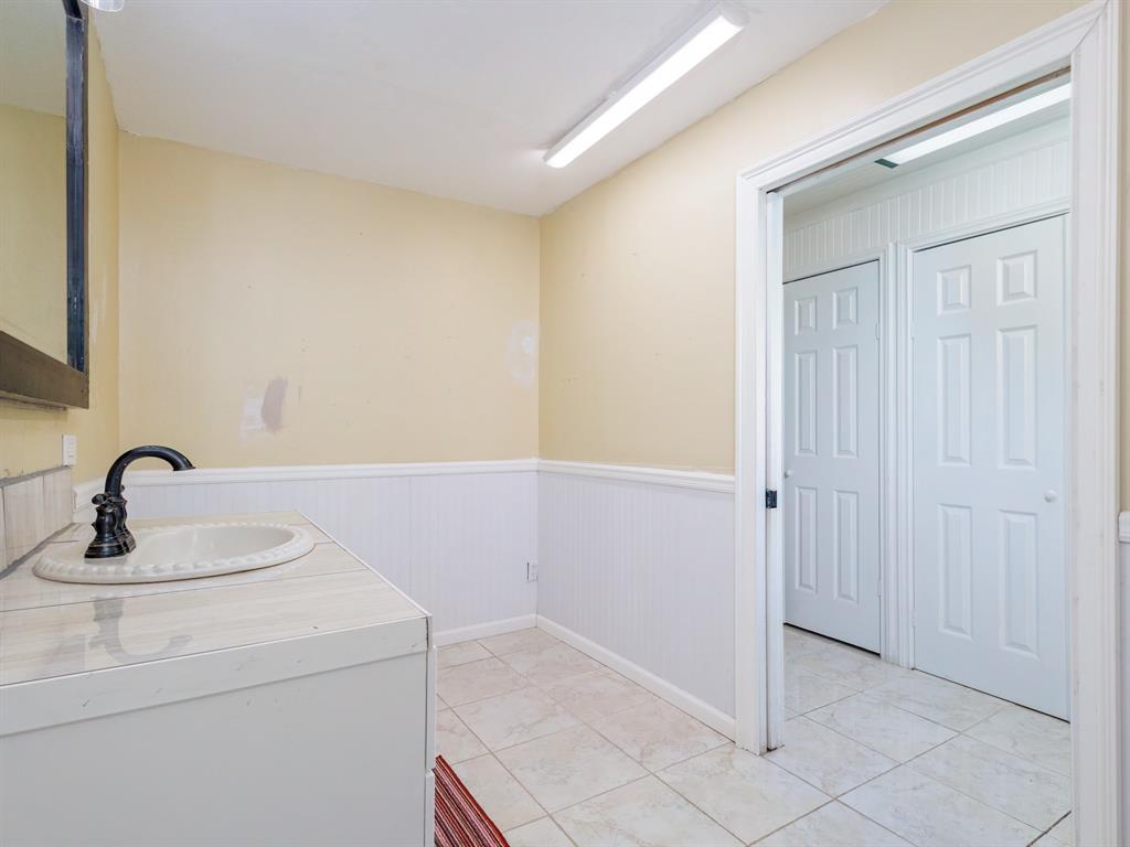 4002 Austin Avenue Brownwood, TX 76801 - Photo 15 of 34 a bathroom with a sink and a mirror