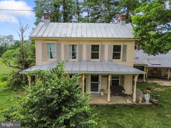 a front view of a house with garden and porch