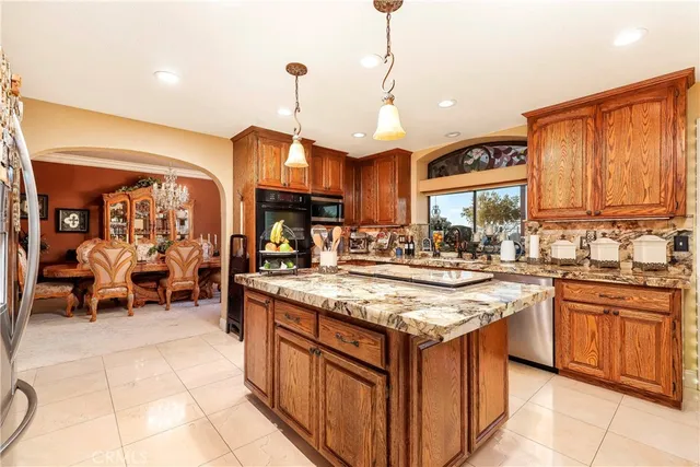 a large kitchen with a table and chairs