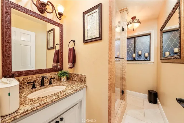 a bedroom with furniture a flat screen tv and a fireplace