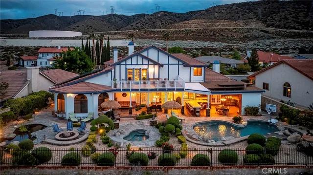 an aerial view of a house with garden space and outdoor seating