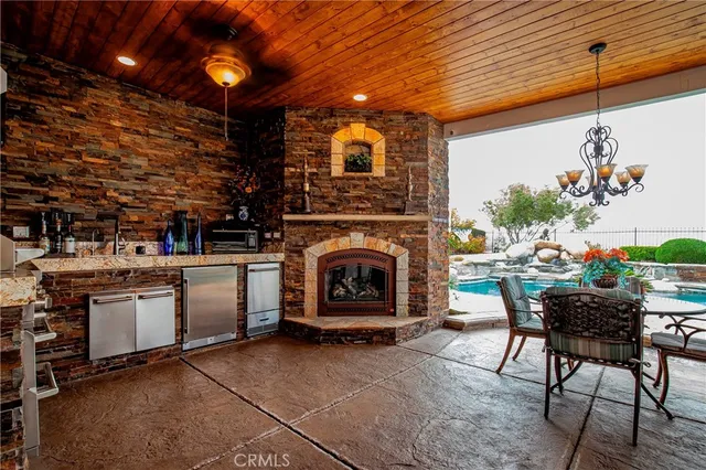 a view of a swimming pool with a patio and a yard