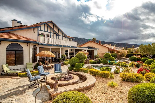 an aerial view of a house with swimming pool and a yard