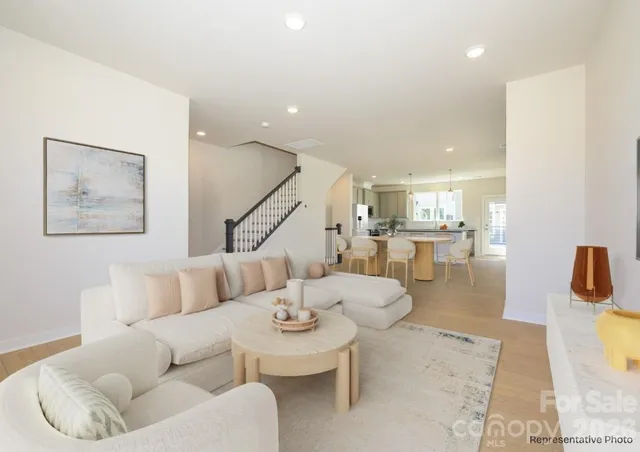 a living room with furniture and kitchen view