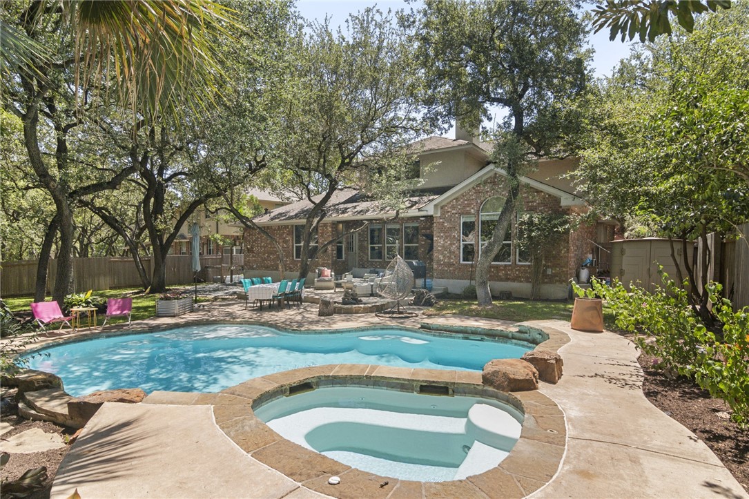 a view of a house with swimming pool and sitting area