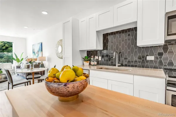a kitchen with sink cabinets and wooden floor
