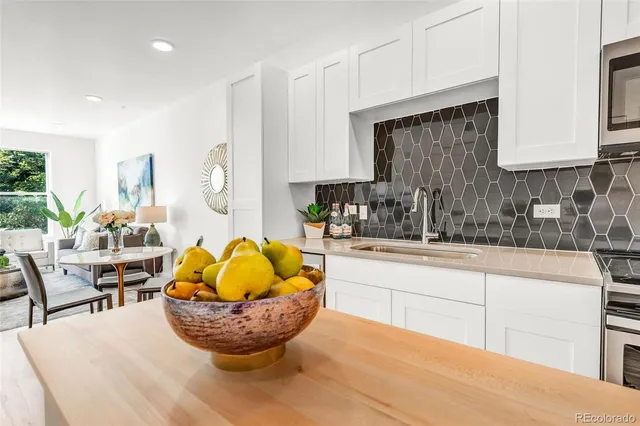 a kitchen with sink cabinets and wooden floor