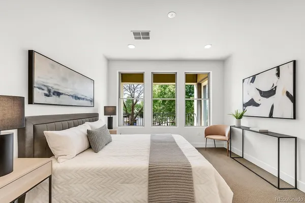 a bathroom with a granite countertop sink a toilet and shower