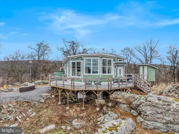 a view of a house with a yard chairs and table in patio