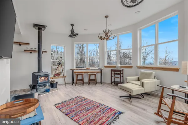 a living room with furniture a chandelier and a table