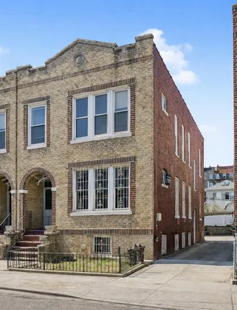 a front view of a building with a road
