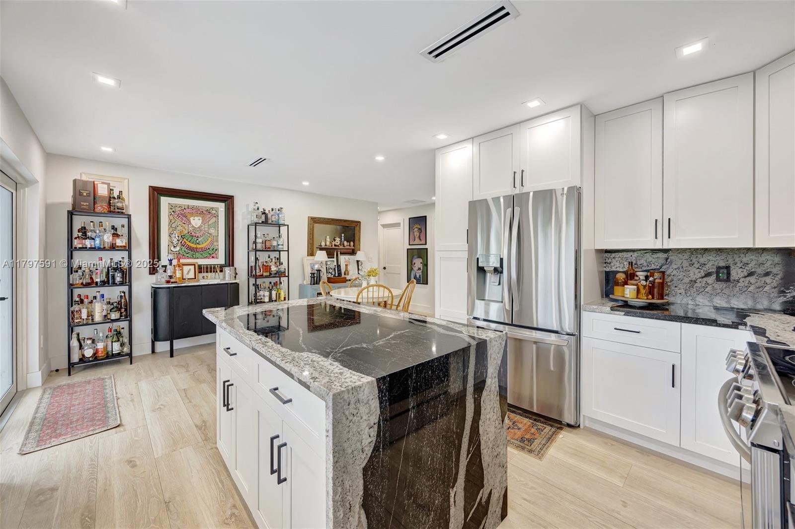 9547 Southwest 59th Terrace Miami, FL 33173 - Photo 17 of 51 a kitchen with stainless steel appliances granite countertop a refrigerator and a stove top oven