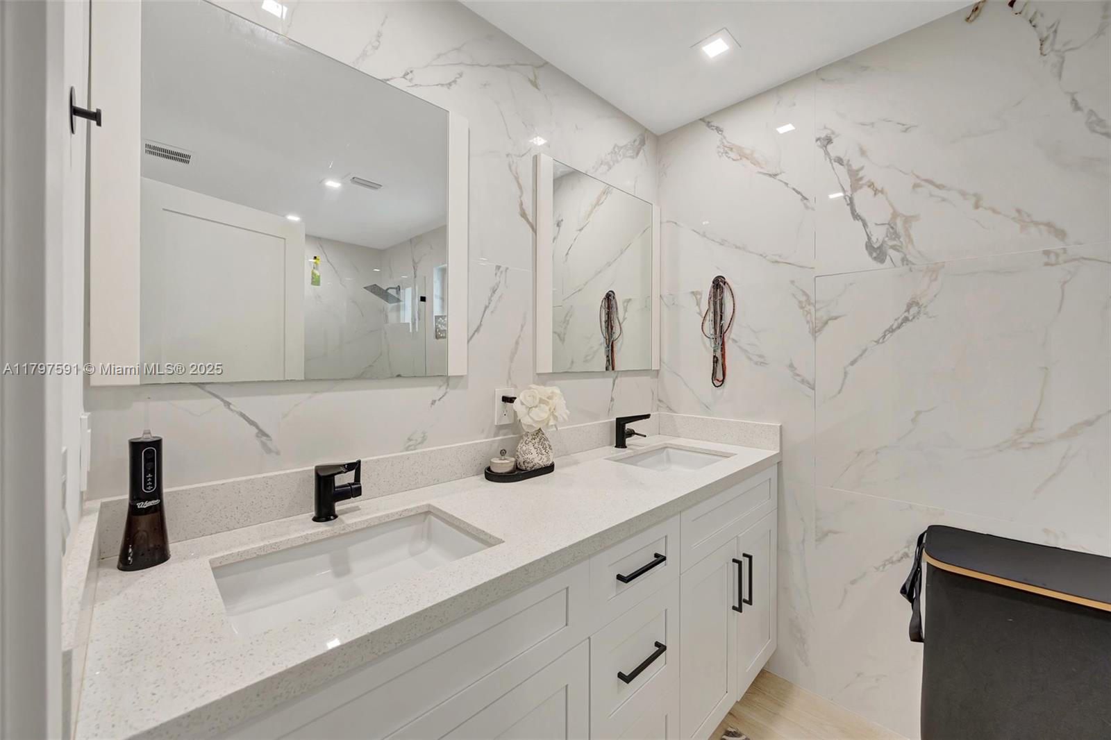 9547 Southwest 59th Terrace Miami, FL 33173 - Photo 22 of 51 a bathroom with double vanity sink and mirror