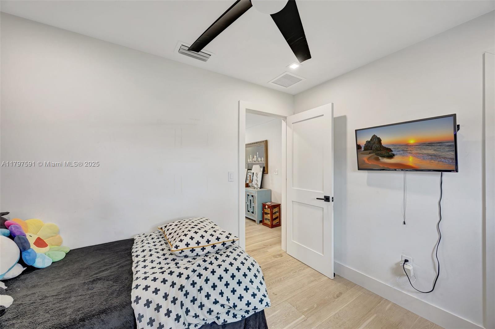 9547 Southwest 59th Terrace Miami, FL 33173 - Photo 31 of 51 a bedroom with a bed and wooden floor