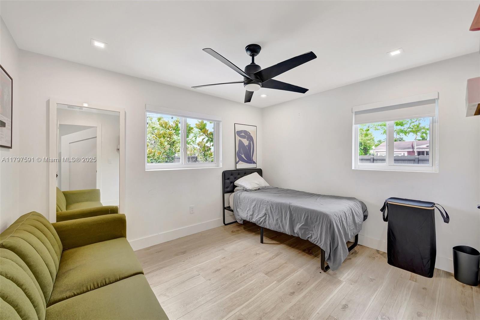 9547 Southwest 59th Terrace Miami, FL 33173 - Photo 33 of 51 a living room with a bed furniture and a window