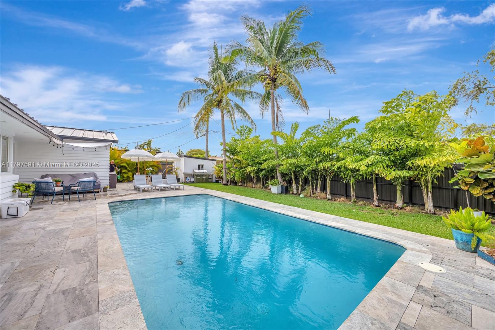 9547 Southwest 59th Terrace Miami, FL 33173 - Photo 43 of 51 a swimming pool with outdoor seating and yard