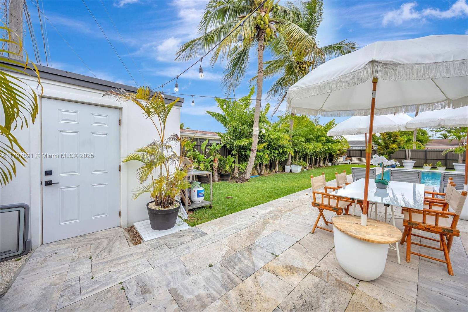 9547 Southwest 59th Terrace Miami, FL 33173 - Photo 46 of 51 a view of a patio with a table and chairs under an umbrella