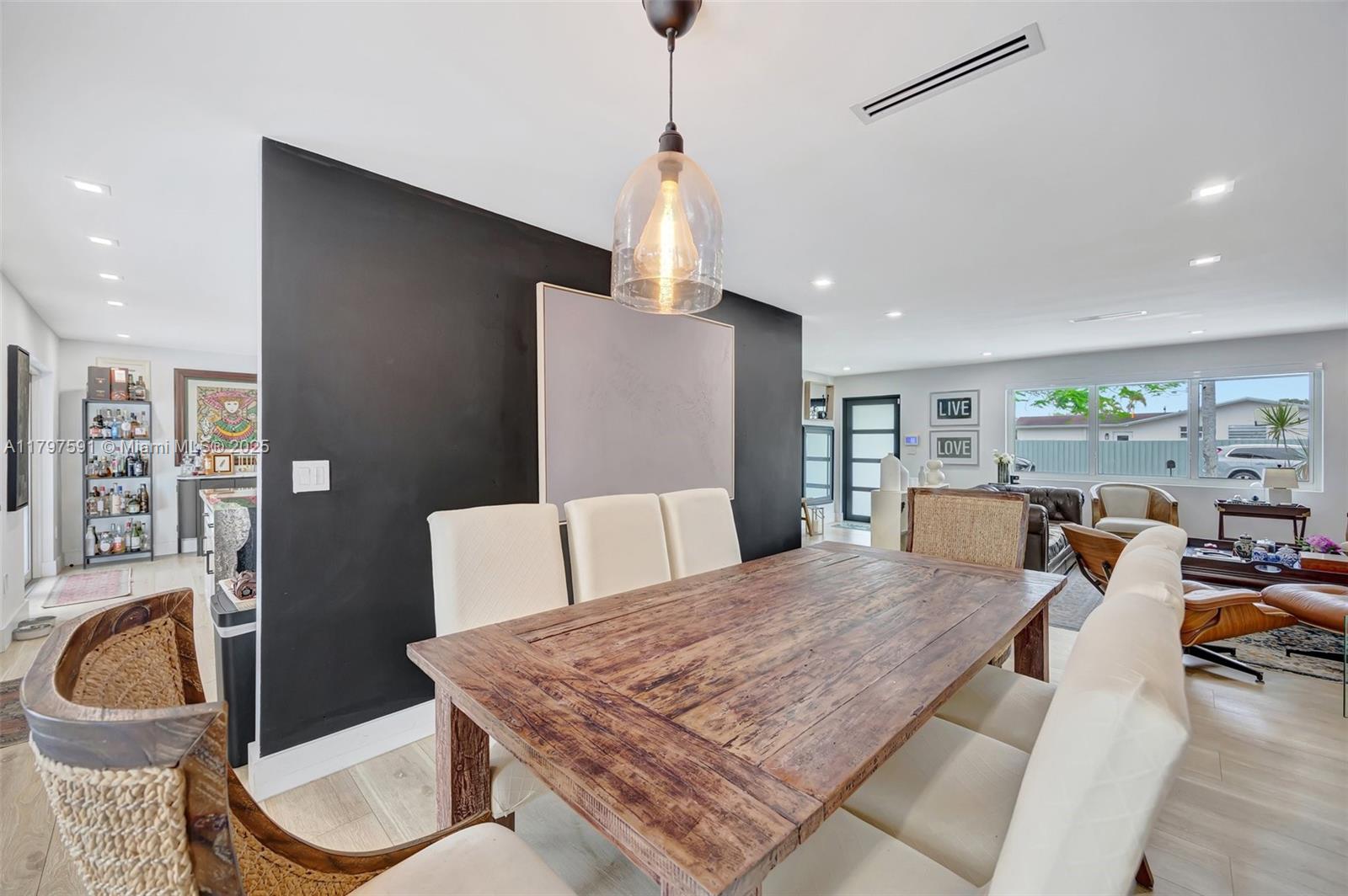 9547 Southwest 59th Terrace Miami, FL 33173 - Photo 9 of 51 a living room with dining table and a couch