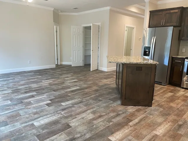 a view of a refrigerator in kitchen and wooden floor