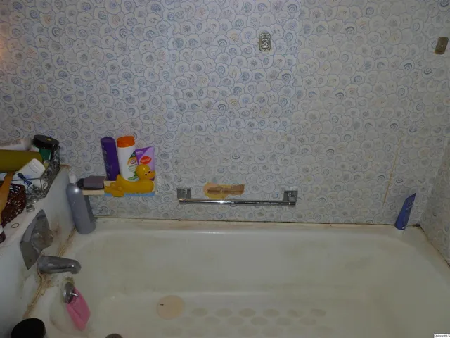 a bedroom with a bed and a wall painting