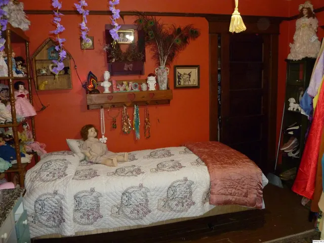 a bed sitting in a bedroom next to a window