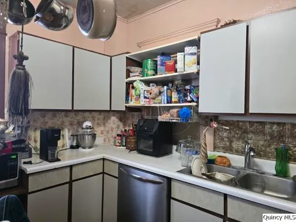 a kitchen with a sink cabinets and appliances