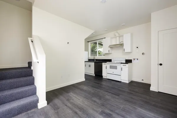 a kitchen with stainless steel appliances a refrigerator and a stove top oven